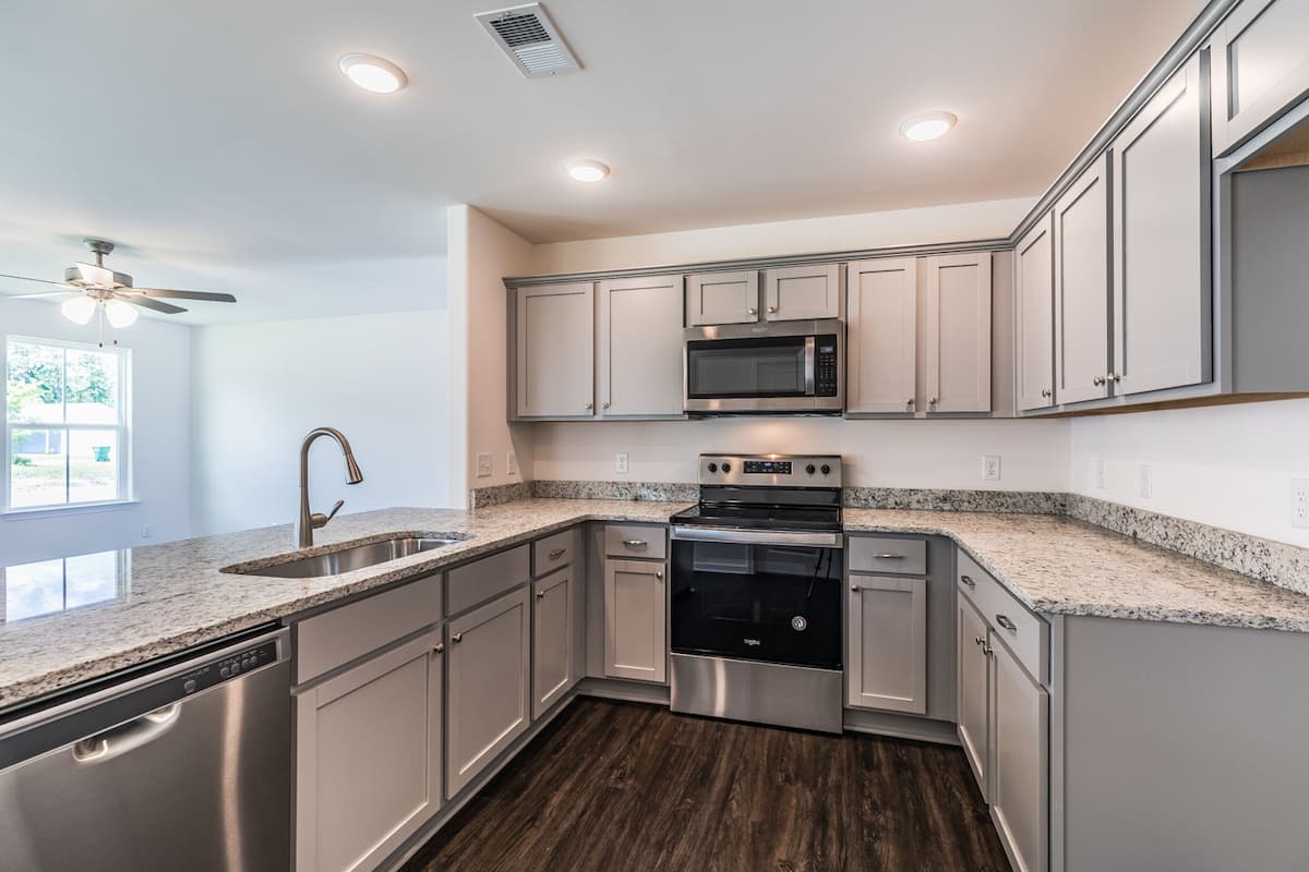 fully furnished kitchen with brand new silver appliances and marble countertop